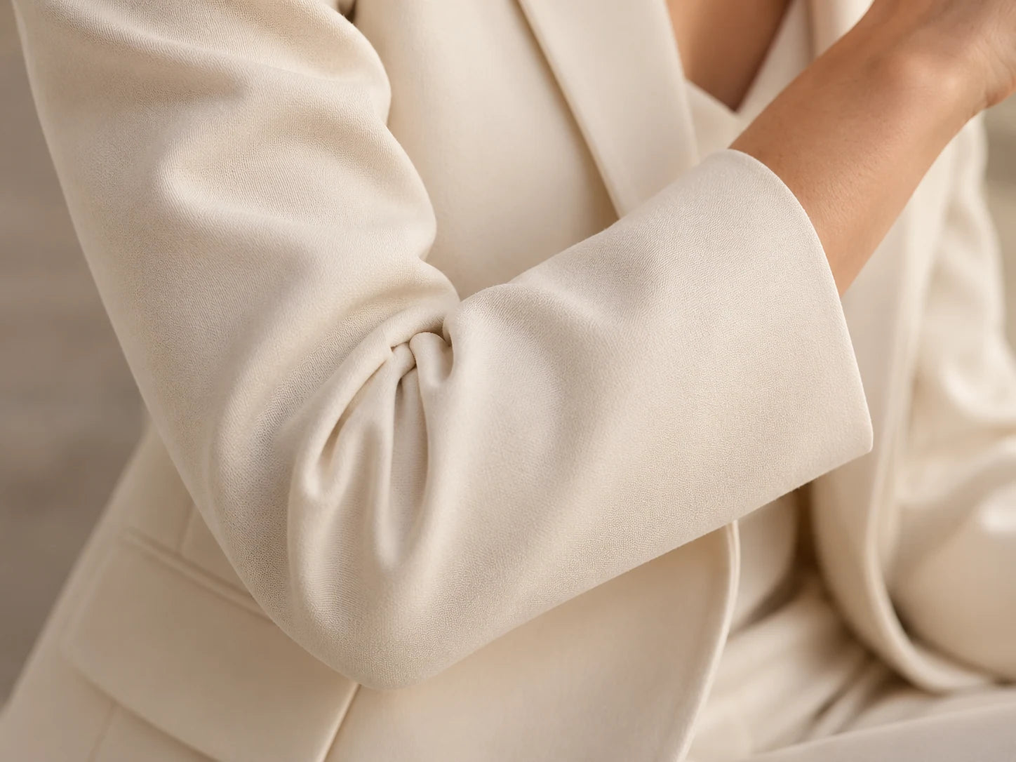 City Ivory Blazer, Ivory: Sleeve detail; AI design preview, not verified merchandise evidence
