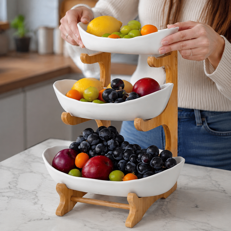 Three-tier fruit basket stand with white trays on a kitchen counter